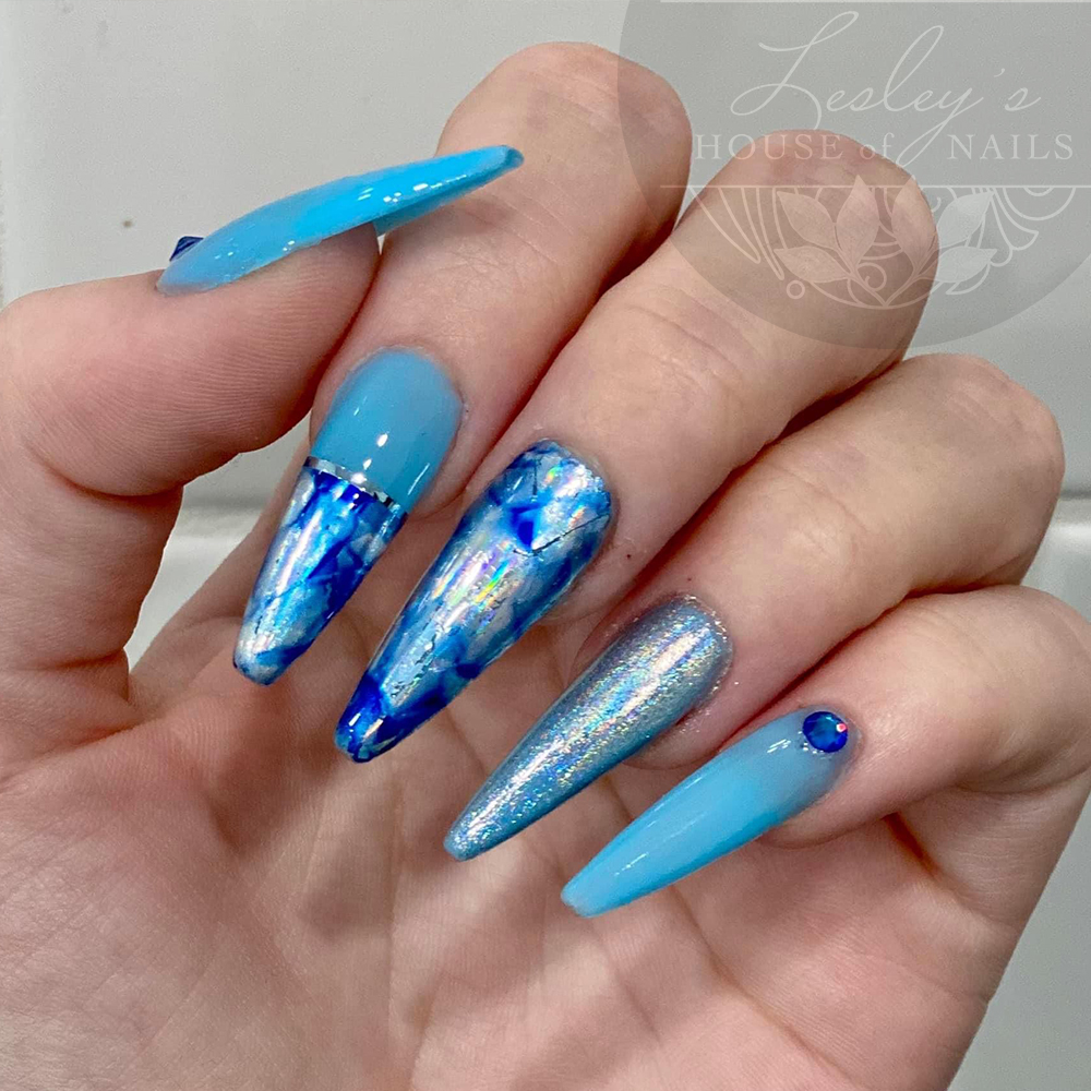 Extensions with foil, chrome and gemstone nail art